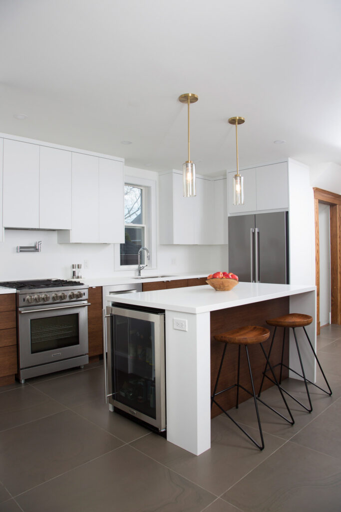 modern white kitchen with dark wood lower cabinets
